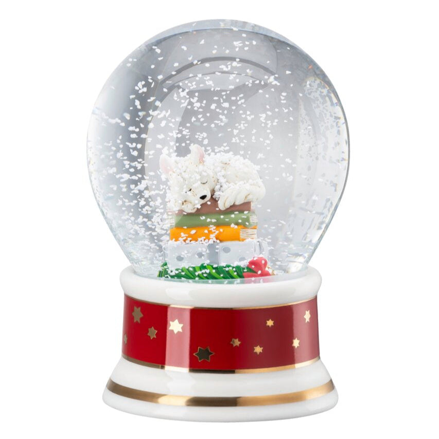 Christmas-themed snow globe with a red base and decorative elements on a white background