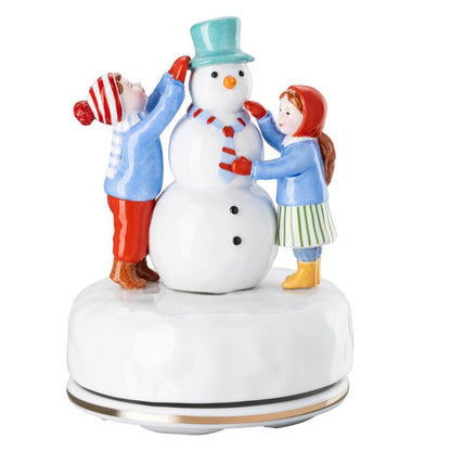 Decorative figurine with a snowman and three people on a white background