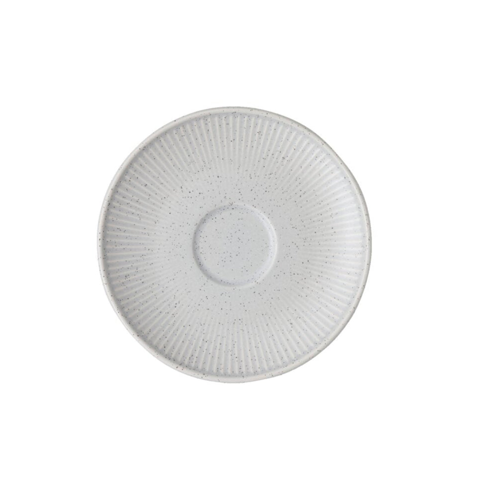 White ceramic saucer with textured design on a white background